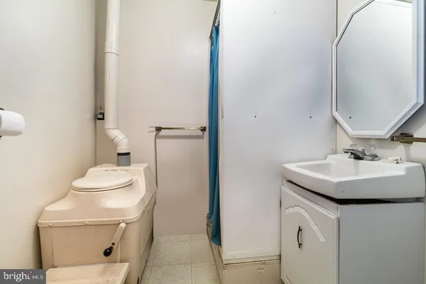 a bathroom with a toilet sink and mirror