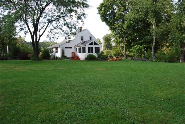 52 Lancaster Road Shirley, MA 01464 - Photo 3 of 29 a front view of a house with a garden