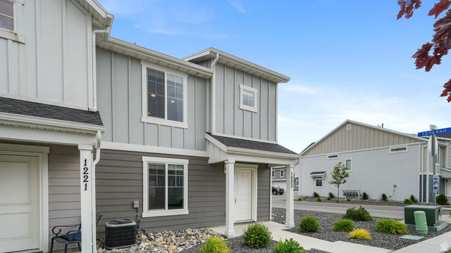 1223 East 1775 North Payson, UT 84651 - Photo 42 of 45 Contemporary facade featuring vertical and horizontal siding, white trim windows, and a covered entry