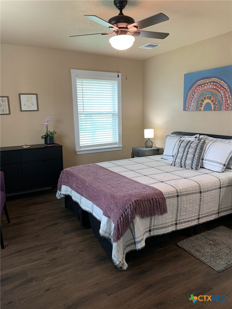 952 Fannin Loop Temple, TX 76501 - Photo 14 of 17 a bedroom with a bed and wooden floor