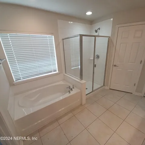 a bathroom with a bathtub and a shower