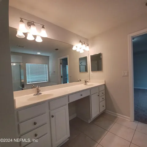 a bathroom with a sink vanity and mirror