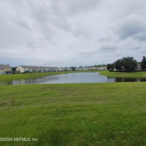a view of a lake with houses in the background