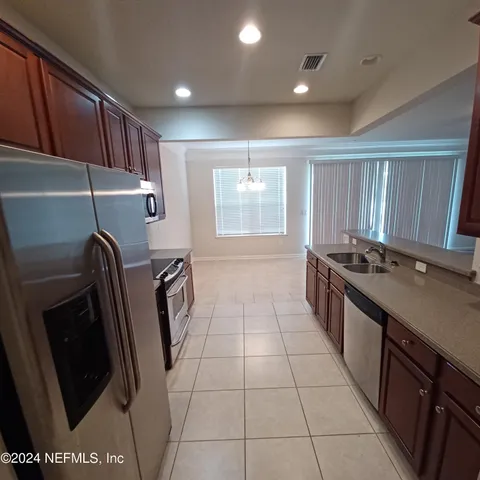 a kitchen with a sink a stove and washer