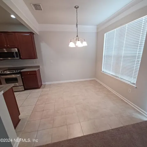 a view of a kitchen with microwave and cabinets