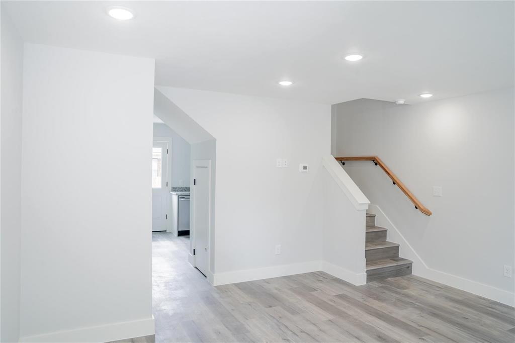 318 Henderson Street Bonham, TX 75418 - Photo 11 of 12 a view of hallway with stairs and wooden floor