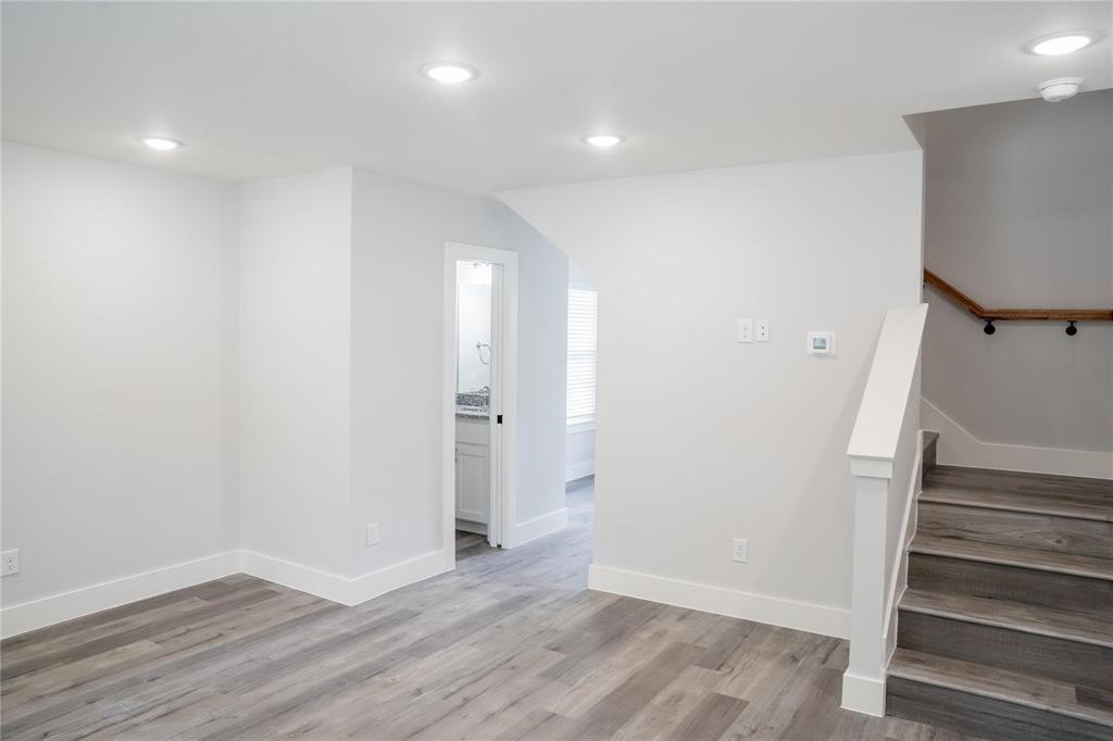 318 Henderson Street Bonham, TX 75418 - Photo 5 of 12 a view of an empty room with wooden floor and entryway