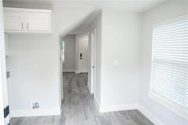 a view of a hallway with wooden floor