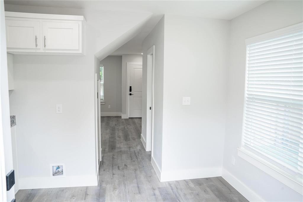 318 Henderson Street Bonham, TX 75418 - Photo 6 of 12 a view of a hallway with wooden floor