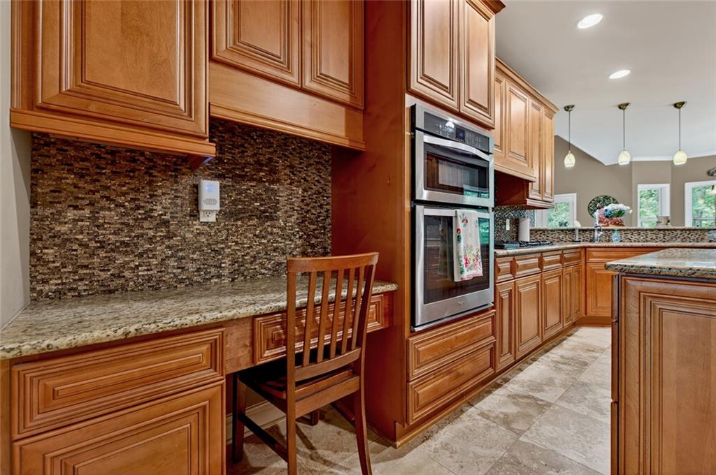3184 St. Andrews Way Ellijay, GA 30536 - Photo 27 of 51 a kitchen with stainless steel appliances granite countertop a stove a sink and a refrigerator