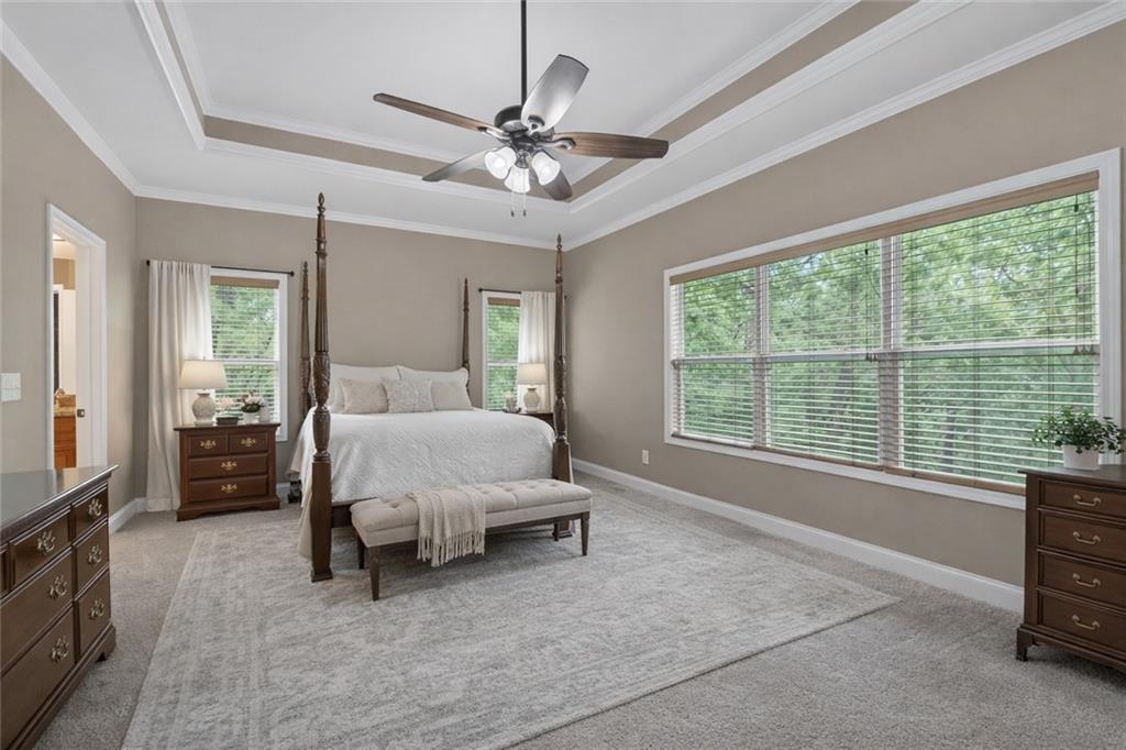 3184 St. Andrews Way Ellijay, GA 30536 - Photo 29 of 51 a bed room with a bed and a chandelier
