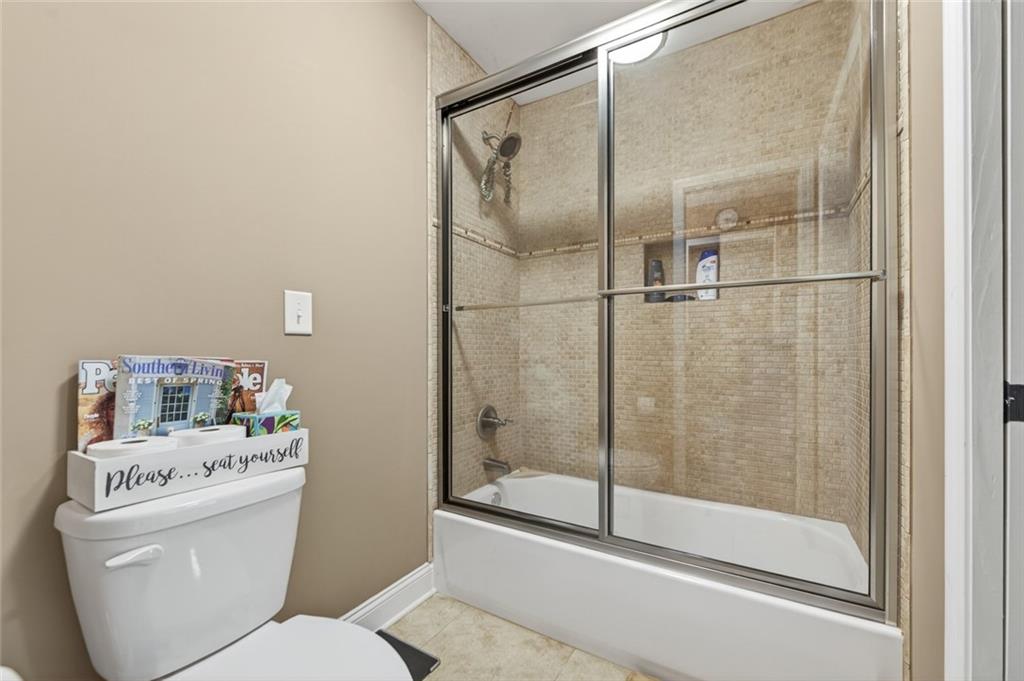 3184 St. Andrews Way Ellijay, GA 30536 - Photo 40 of 51 a bathroom with a shower a toilet and a sink
