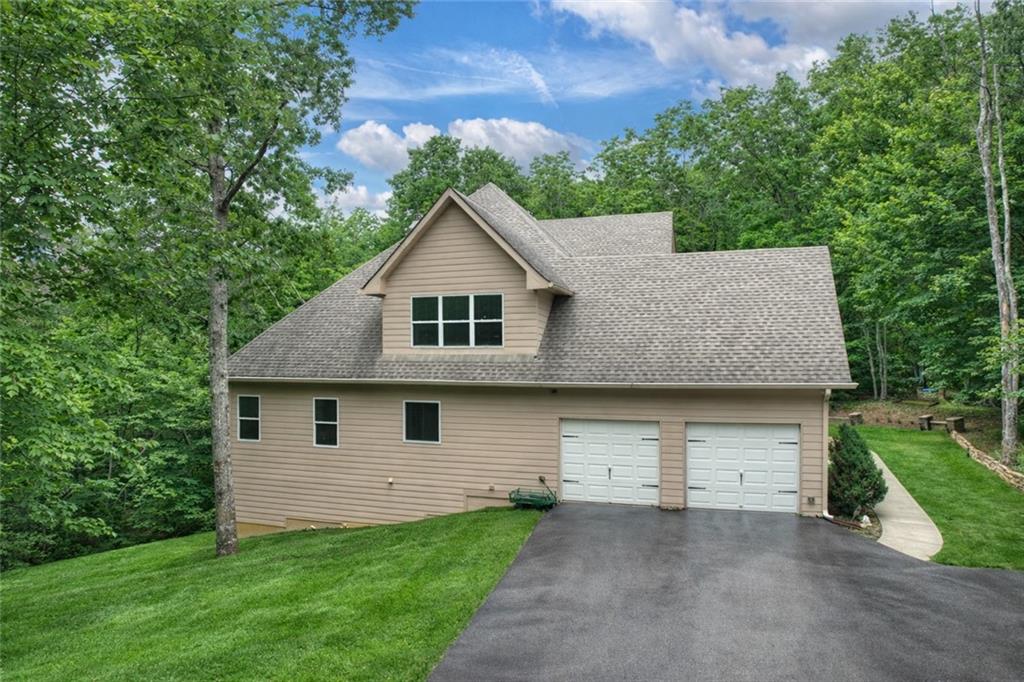 3184 St. Andrews Way Ellijay, GA 30536 - Photo 48 of 51 a front view of a house with a garden and yard