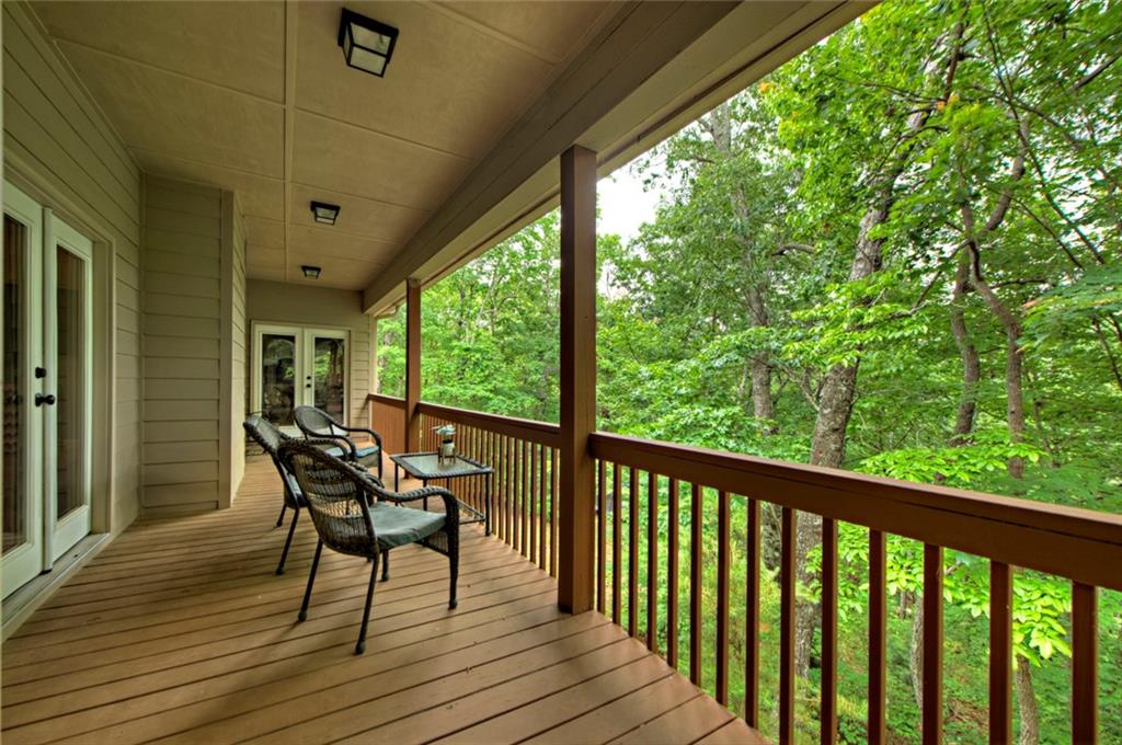 3184 St. Andrews Way Ellijay, GA 30536 - Photo 5 of 51 a view of a chairs and table in deck with wooden floor
