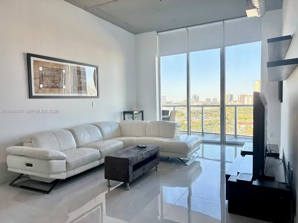 a living room with furniture and a large window