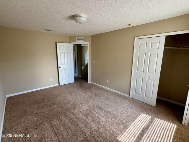 a view of an empty room with a fireplace