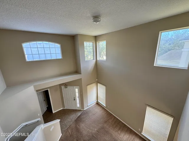 a view of an empty room with windows