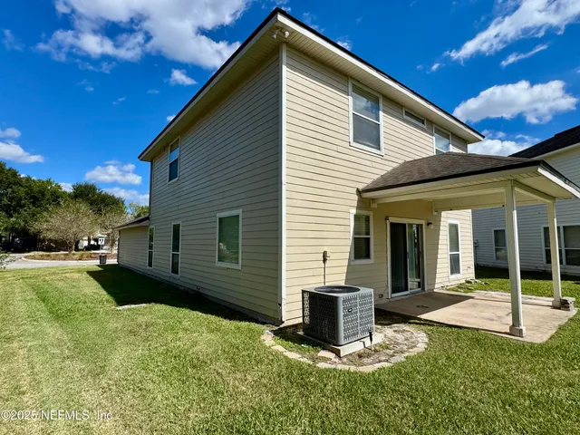 a view of a house with backyard porch and sitting area