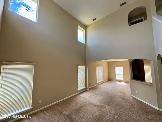 a view of a livingroom with an empty space and a window