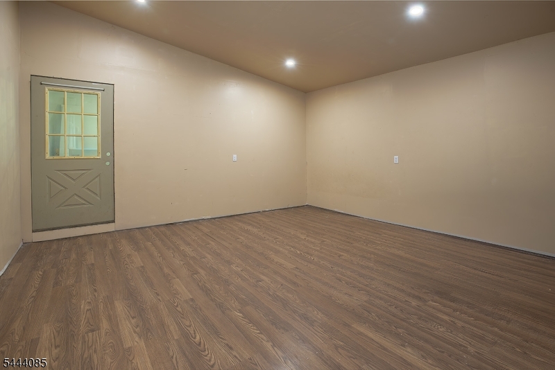 79 Lake Wallkill Road Vernon, NJ 07461 - Photo 13 of 27 an empty room with wooden floor and windows