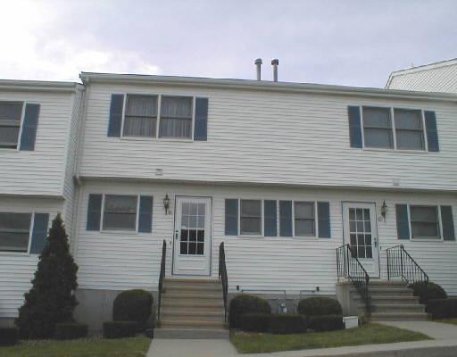 56 Commodore Commons Court, Unit 56 Derby, CT 06418 - Photo 1 of 1 a front view of a house with a yard