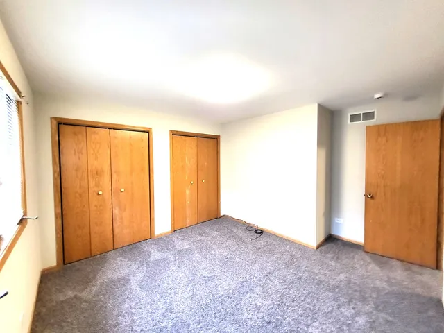 a view of an empty room and a window