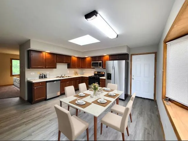 a large kitchen with a table and chairs