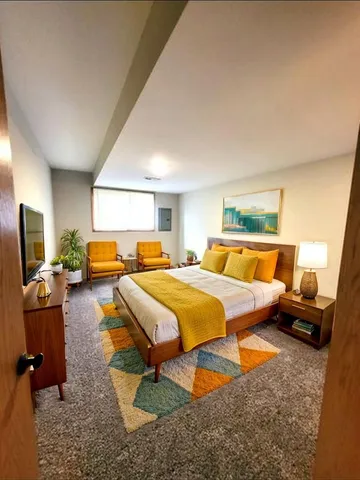 a bedroom with furniture and a flat screen tv