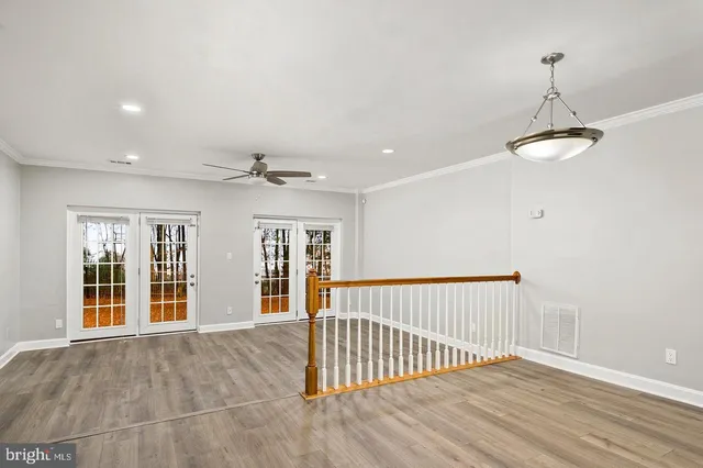 a view of staircase with white walls and railing