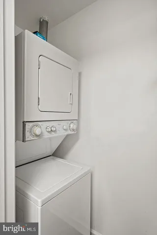 a kitchen with granite countertop white cabinets and stainless steel appliances