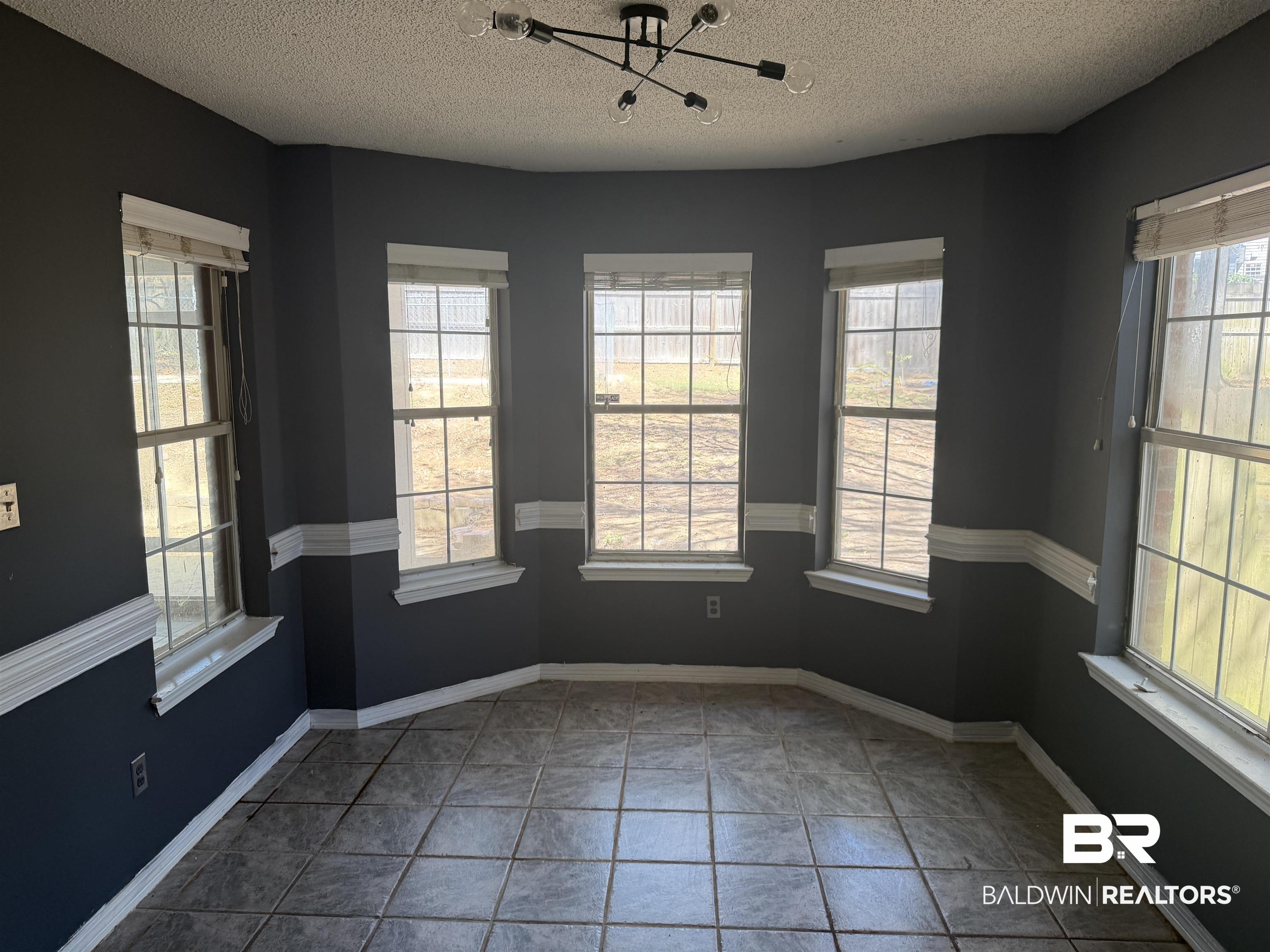 7067 Pinehill Road Daphne, AL 36526 - Photo 9 of 18 Unfurnished dining area with healthy amount of natural light and a textured ceiling