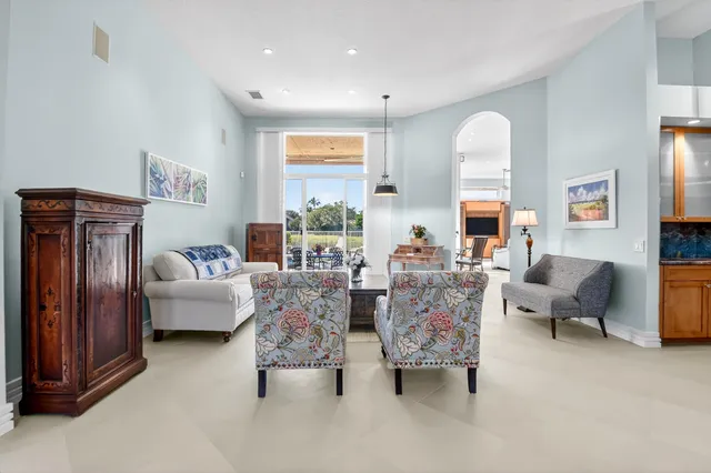 a kitchen with stainless steel appliances granite countertop a stove top oven a sink dishwasher a refrigerator and a dining table with wooden cabinet