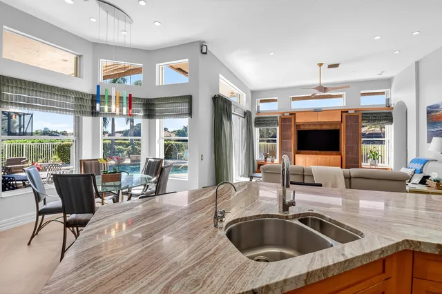 a bedroom with a bed a flat screen tv and a chandelier