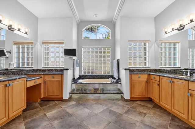 a view of a house with swimming pool and sitting area