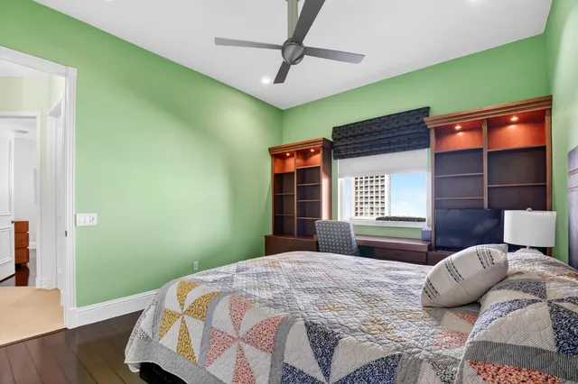 a large room with lots of white furniture and chandelier