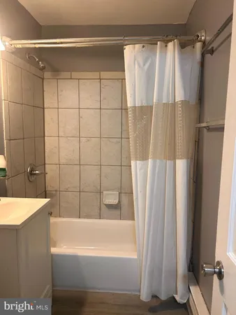a bathroom with a shower and a bath tub