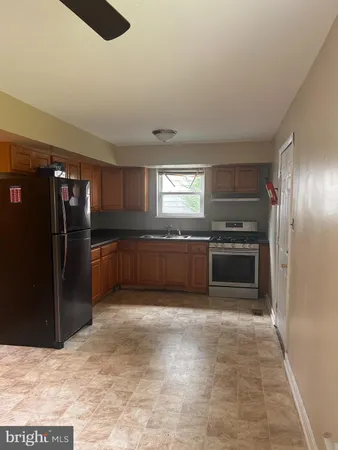 a kitchen with a refrigerator and a sink