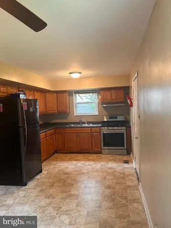 a kitchen with stainless steel appliances a refrigerator and a stove