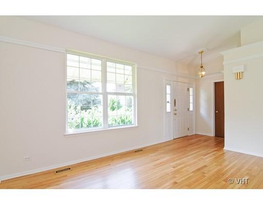 293 Shagbark Court Round Lake, IL 60073 - Photo 2 of 10 a view of an empty room with wooden floor and a window