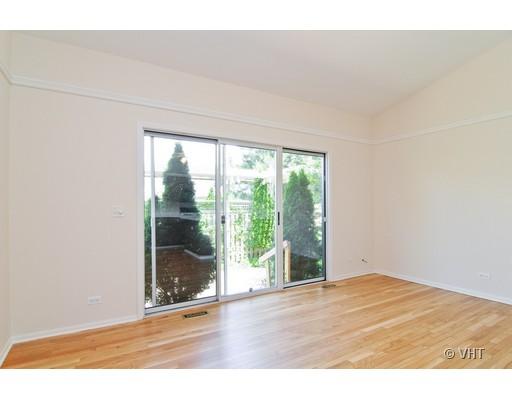 293 Shagbark Court Round Lake, IL 60073 - Photo 4 of 10 a view of an empty room with wooden floor and a window