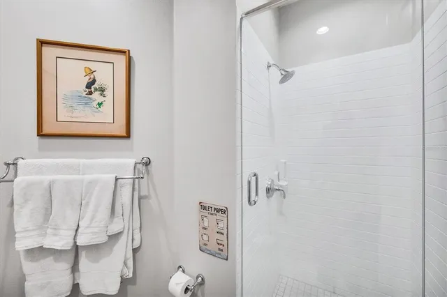 a bathroom with a granite countertop tub sink and mirror