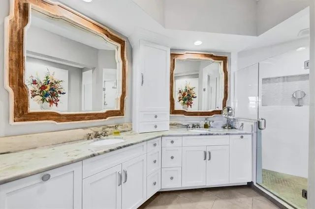 a spacious bathroom with a granite countertop tub sink and mirror