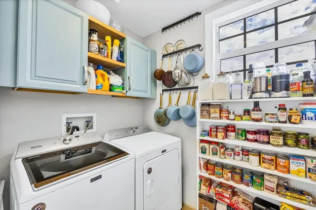 a living room with lots of furniture and a wooden floor