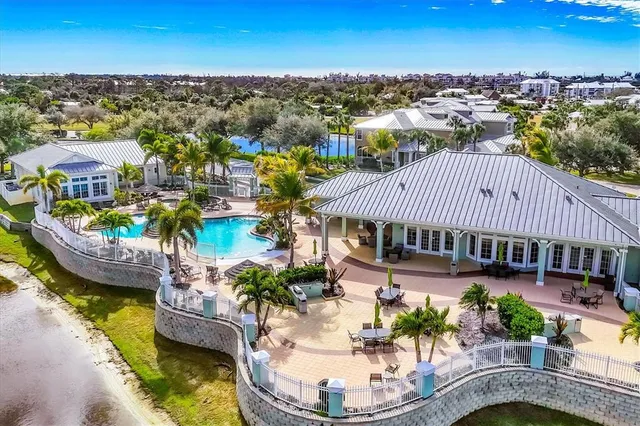 an aerial view of residential houses with outdoor space and swimming pool