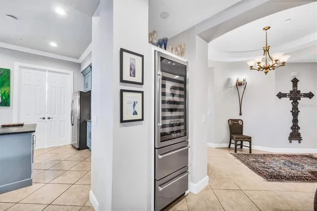 a kitchen with stainless steel appliances kitchen island granite countertop a refrigerator and a sink