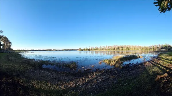 a view of a lake with houses in the back