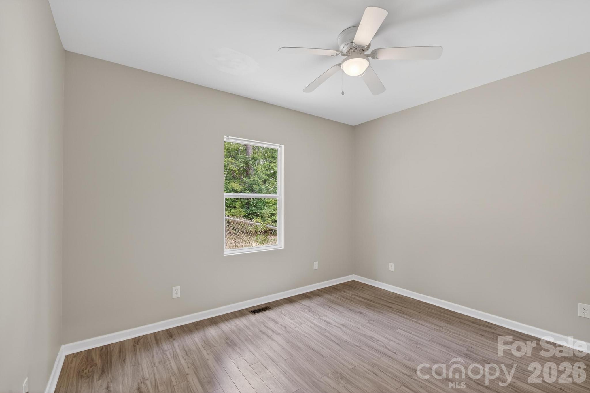 2119 South Road Morganton, NC 28655 - Photo 34 of 47 an empty room with a window and a fan
