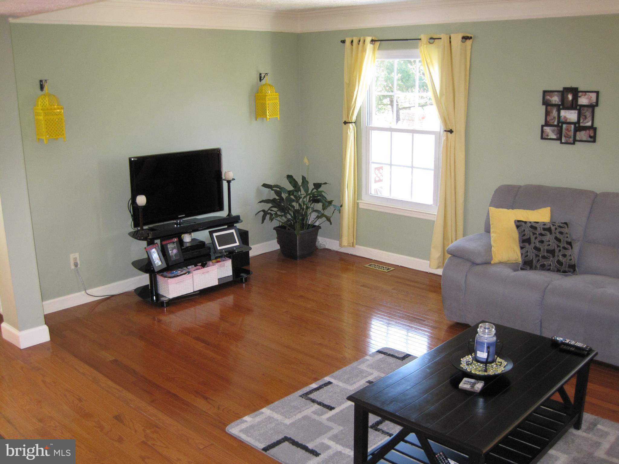 6178 Morning Glory Road Alexandria, VA 22310 - Photo 11 of 26 a living room with furniture and a flat screen tv