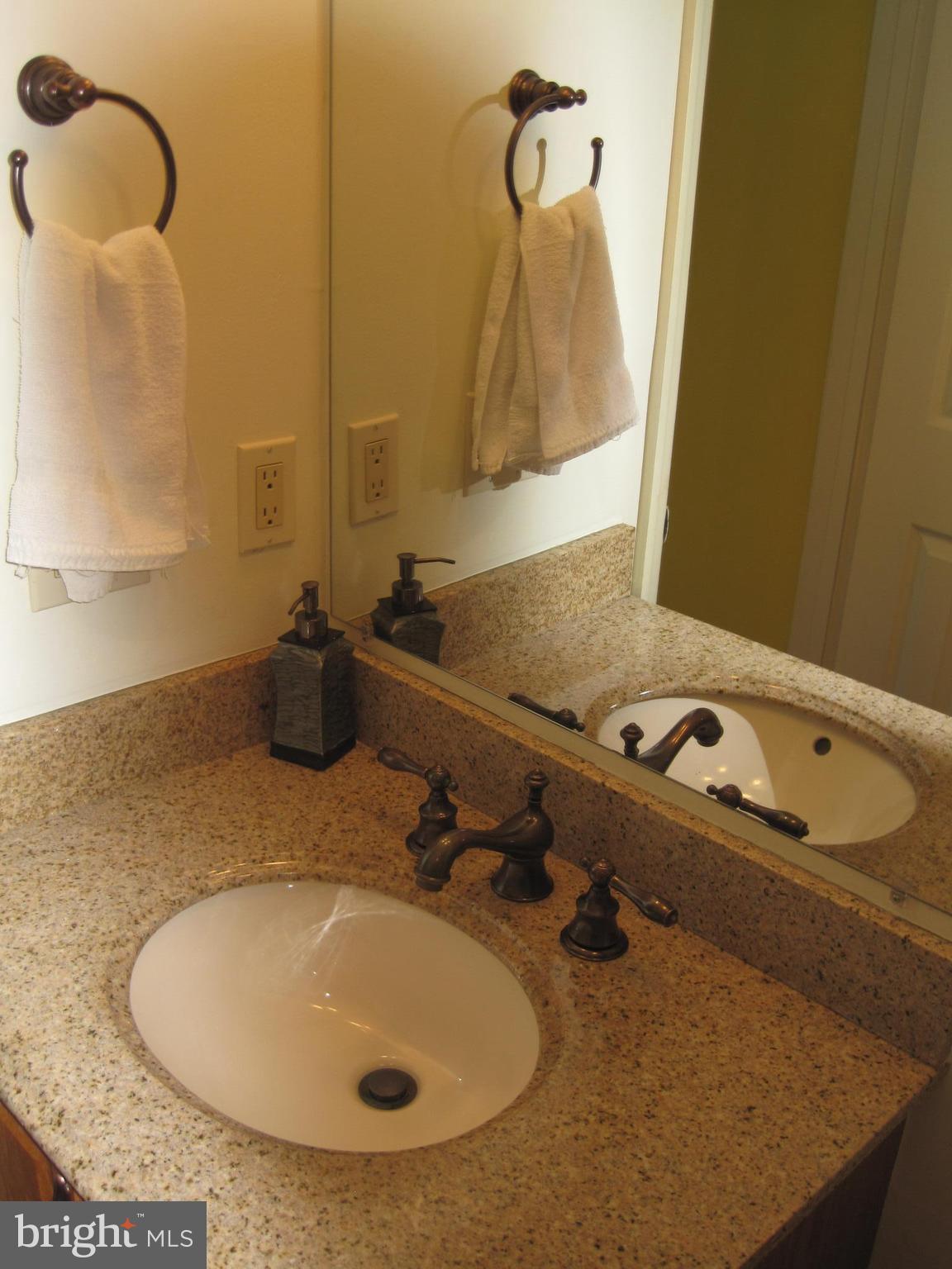 6178 Morning Glory Road Alexandria, VA 22310 - Photo 14 of 26 a bathroom with a sink and mirror