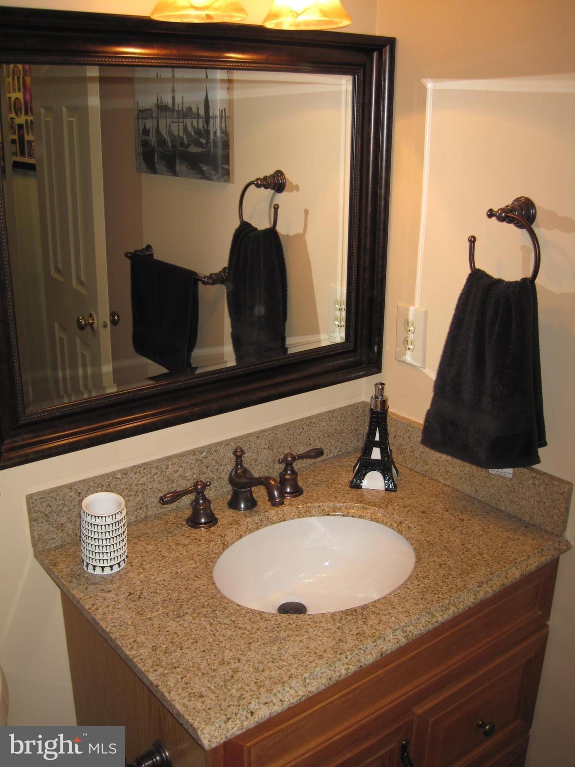6178 Morning Glory Road Alexandria, VA 22310 - Photo 16 of 26 a bathroom with a sink and two mirror